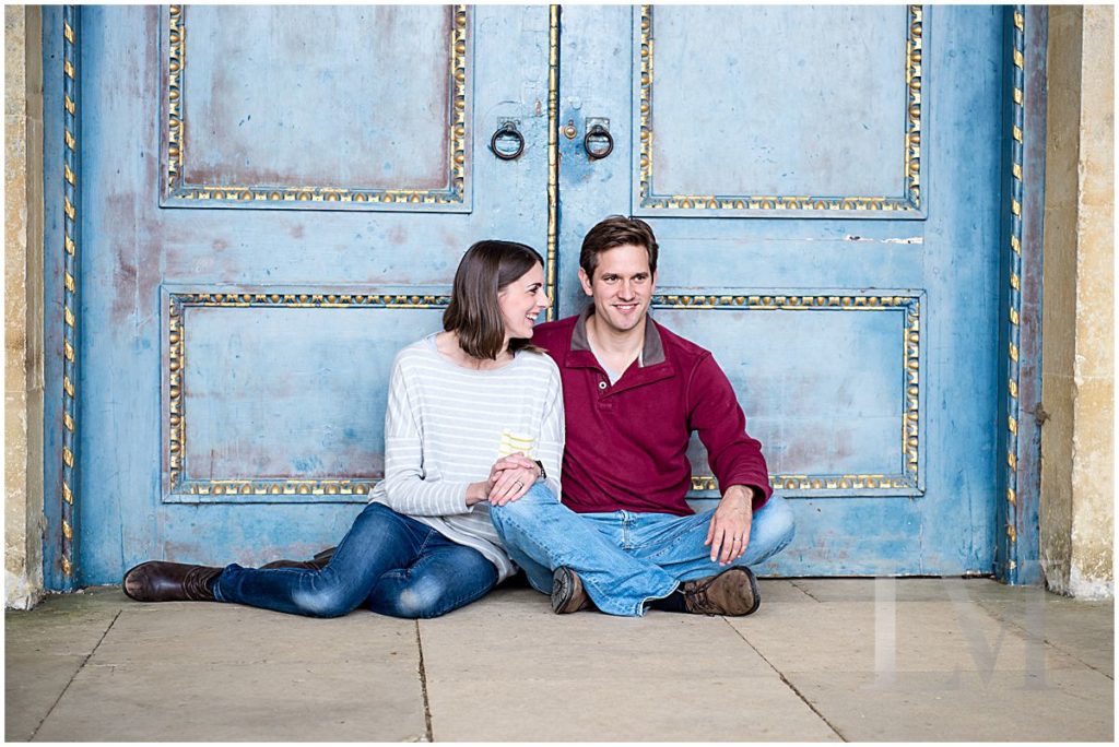 man and woman pose outside blue door in Stowe for photo