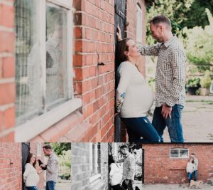 a pregnant woman leaning against a Shropshire wall with her husband with her, kissing her and touching her pregnant belly.