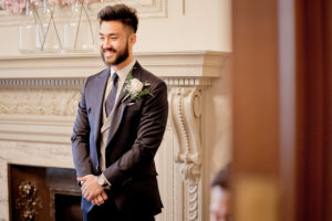 a groom waits for his bride in the Pimlico Room at London's Marylebone Town Hall