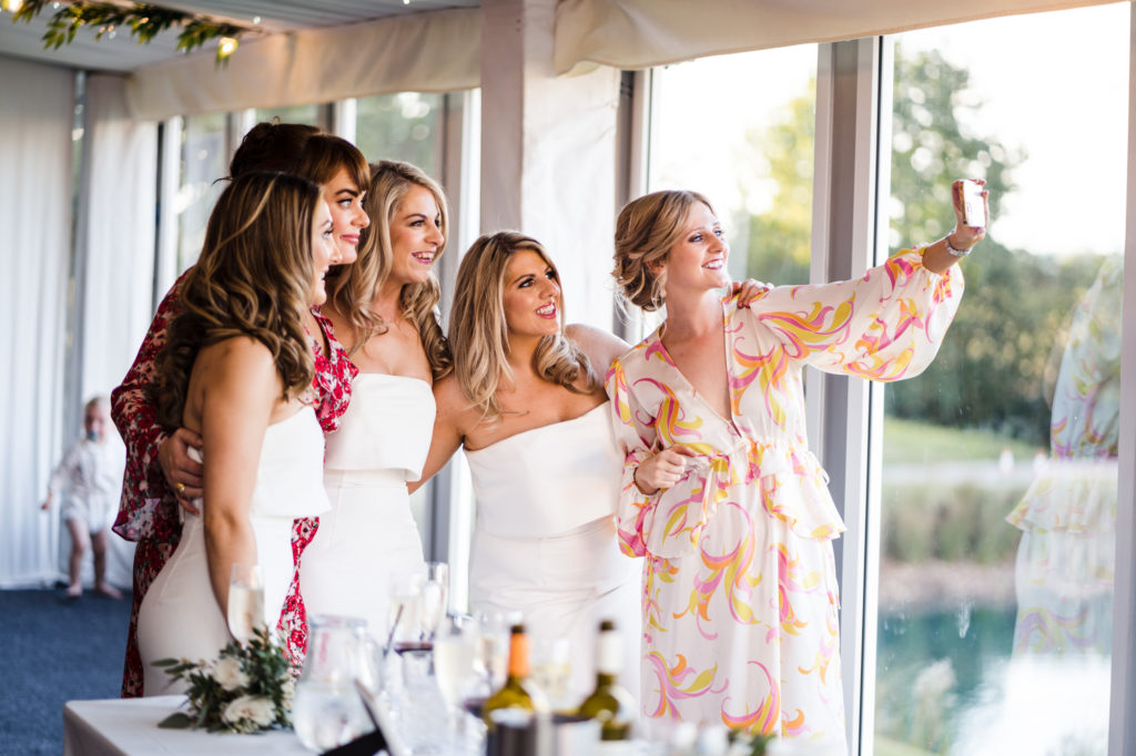 natural photo of wedding guests taking a selfie