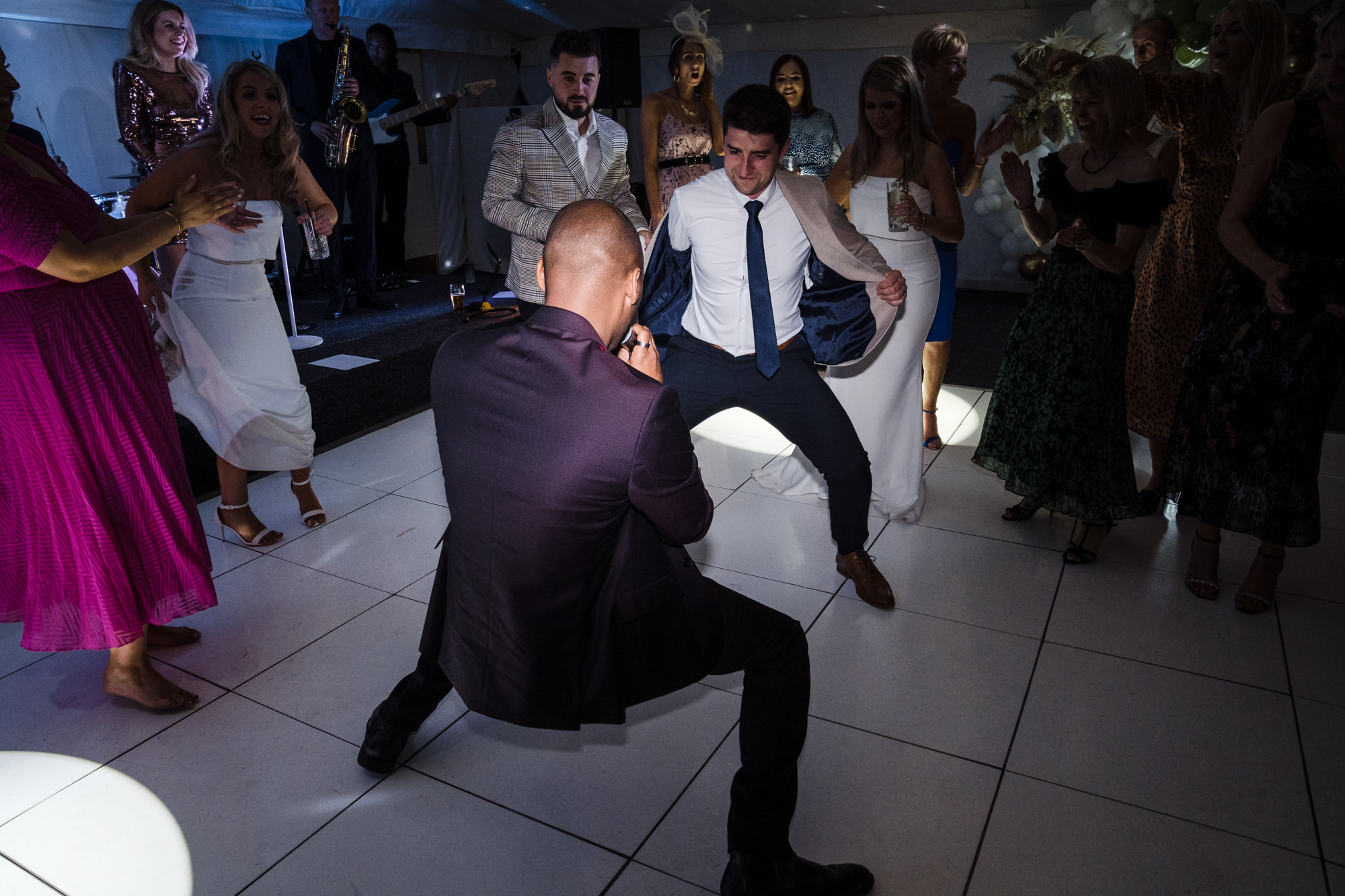 apollo soul singer Dom Hartley dancing and singing in the middle of the dance floor with wedding guest