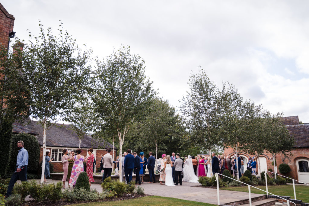 wide shot of alrewas hayes as guest gather for the wedding reception