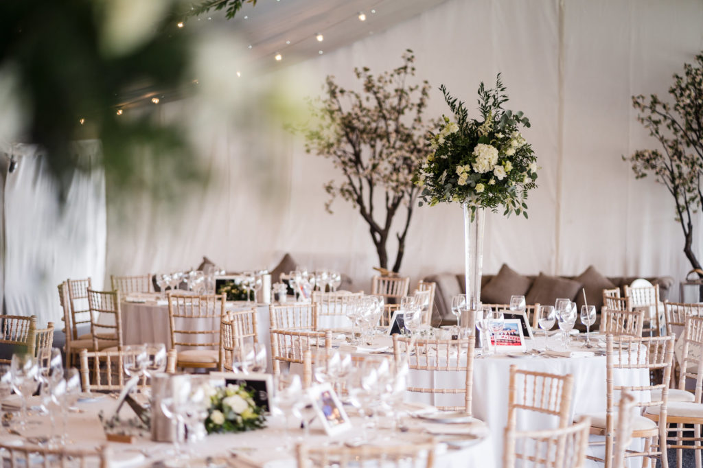 wedding reception image of marquee at alrewas hayes with focus on green floral stand