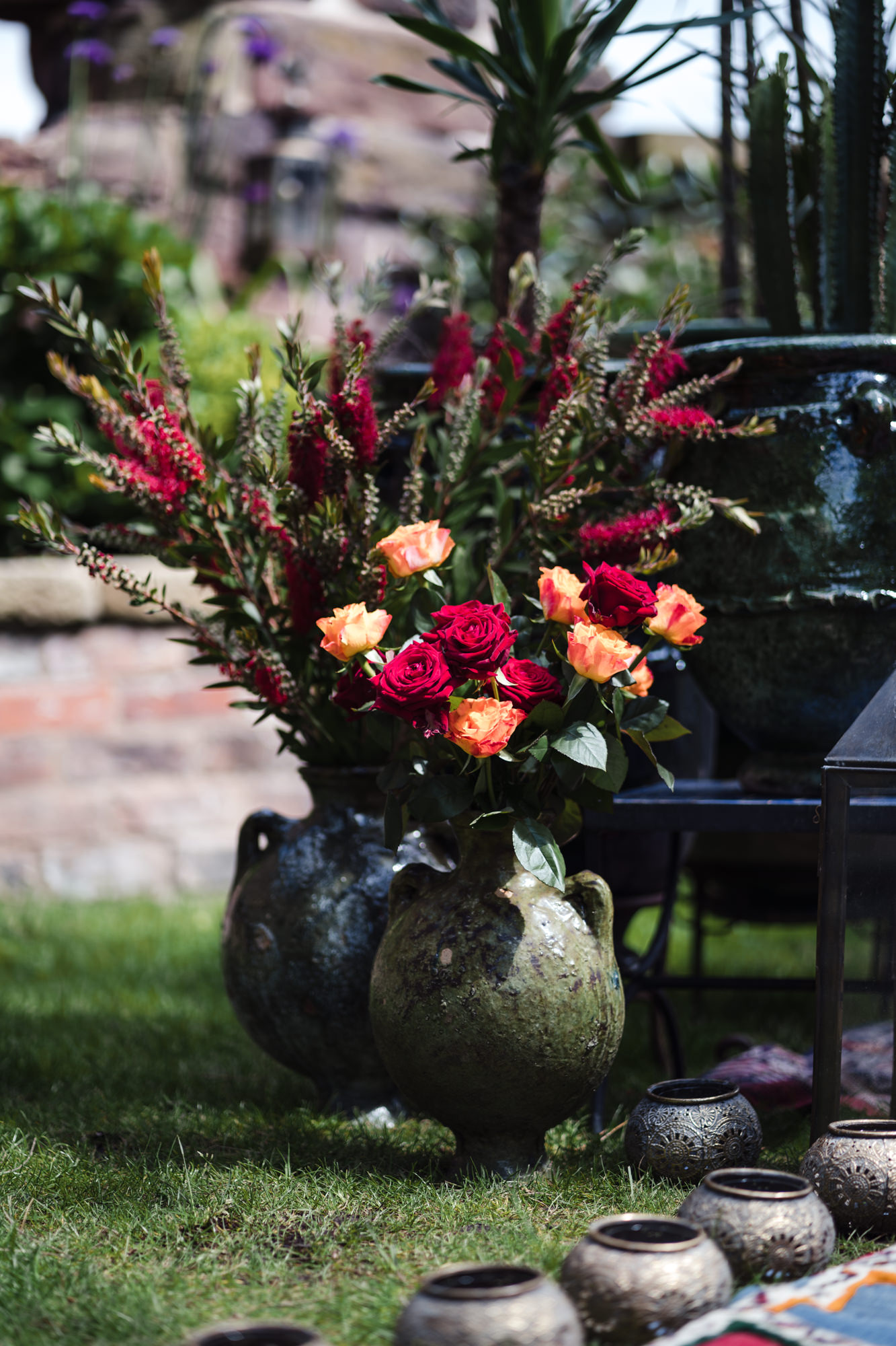 colourful florals of red and orange in a large gren pot