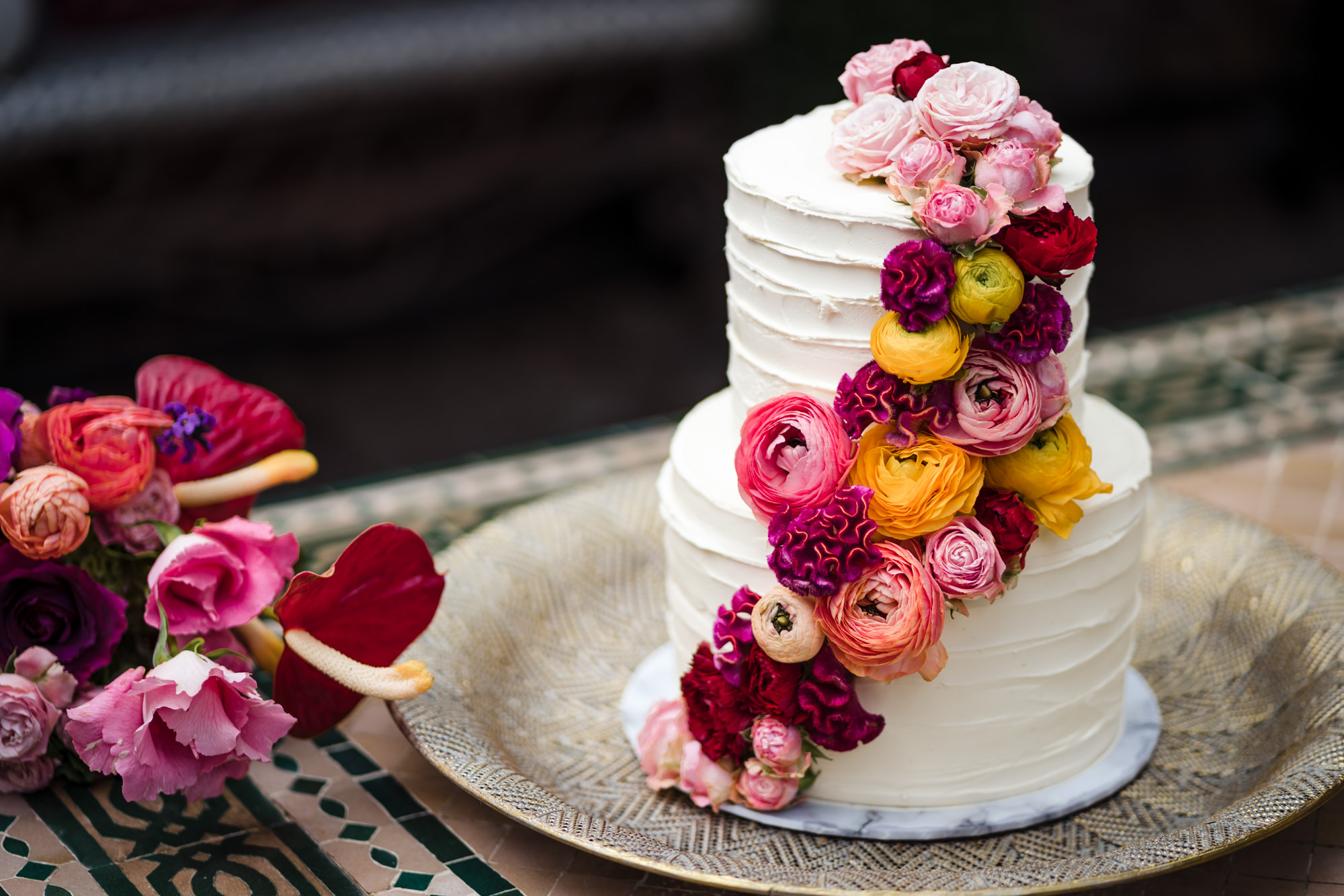 two tier white wedding cake decorated with statement flowers