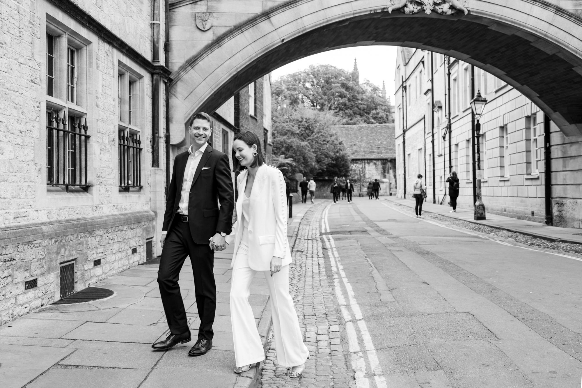 black and white bride and groom couple photo walking past Bridge of Sighs Oxford for their registry office elopement wedding