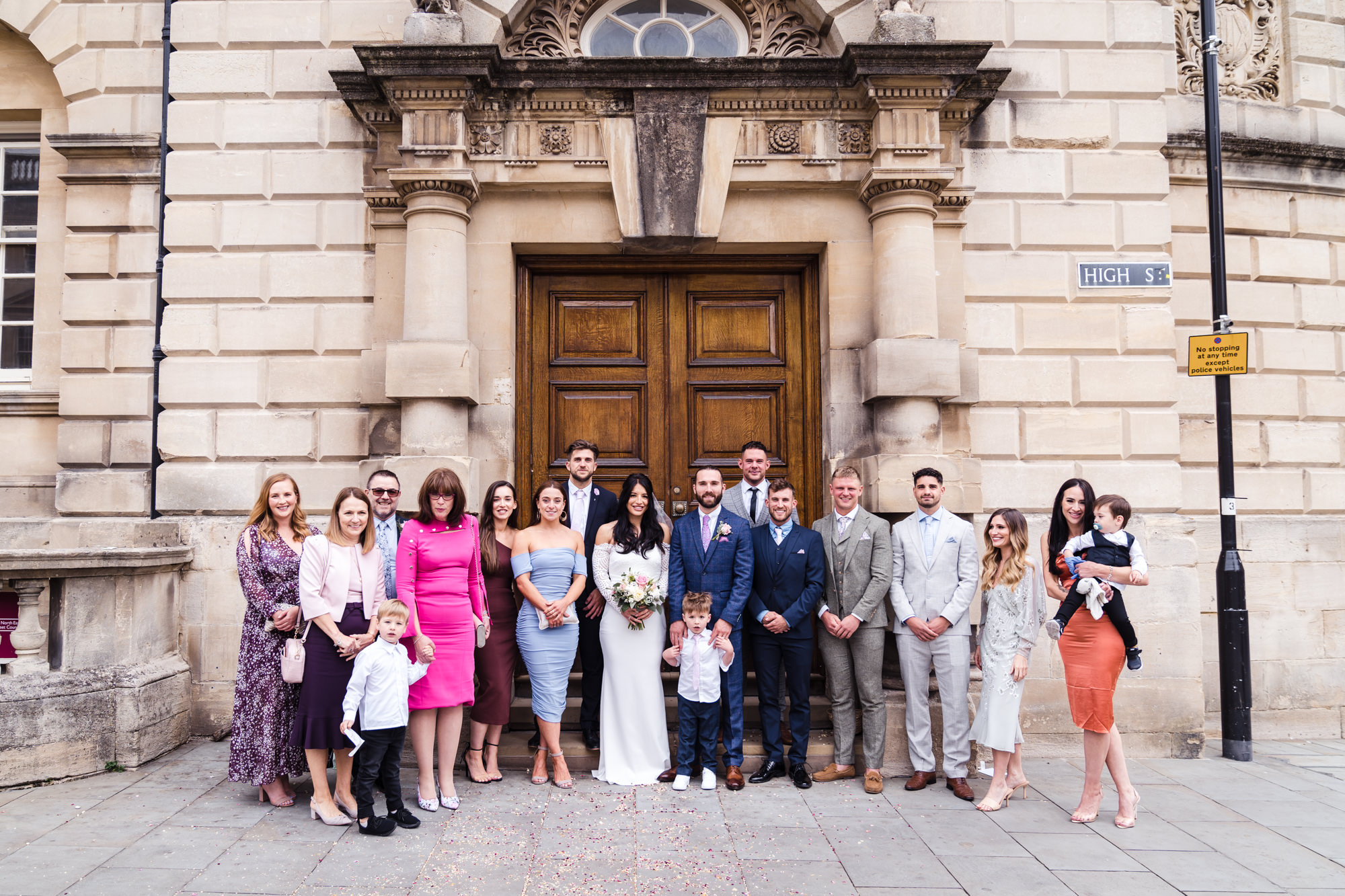 relaxed wedding guest group photo outside bath guildhall