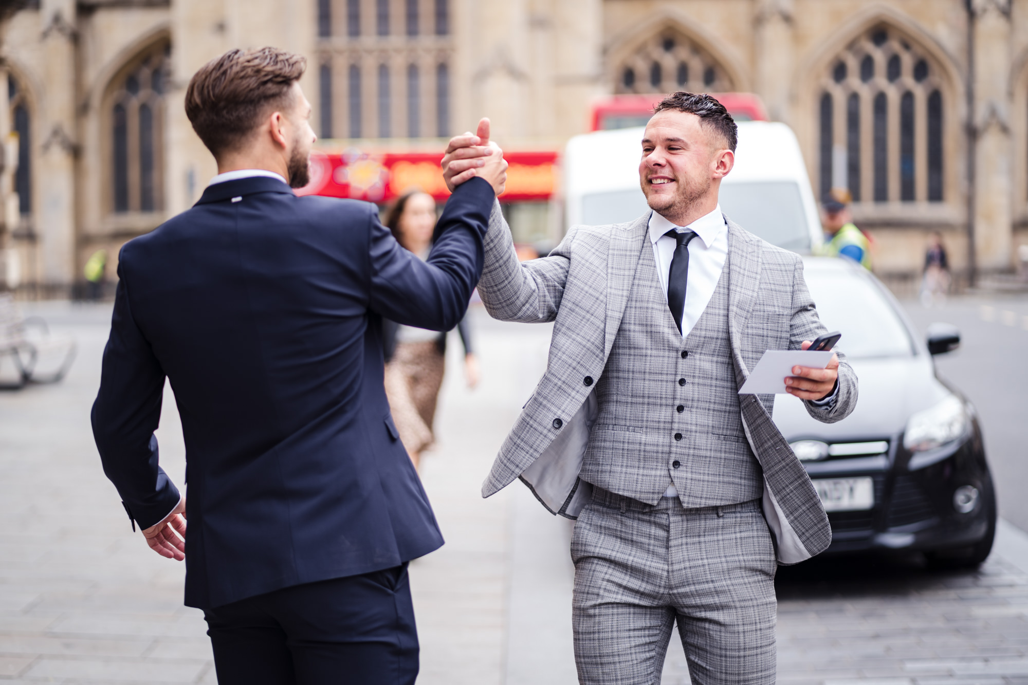 guests high fiving outside Bath Guildhall wedding