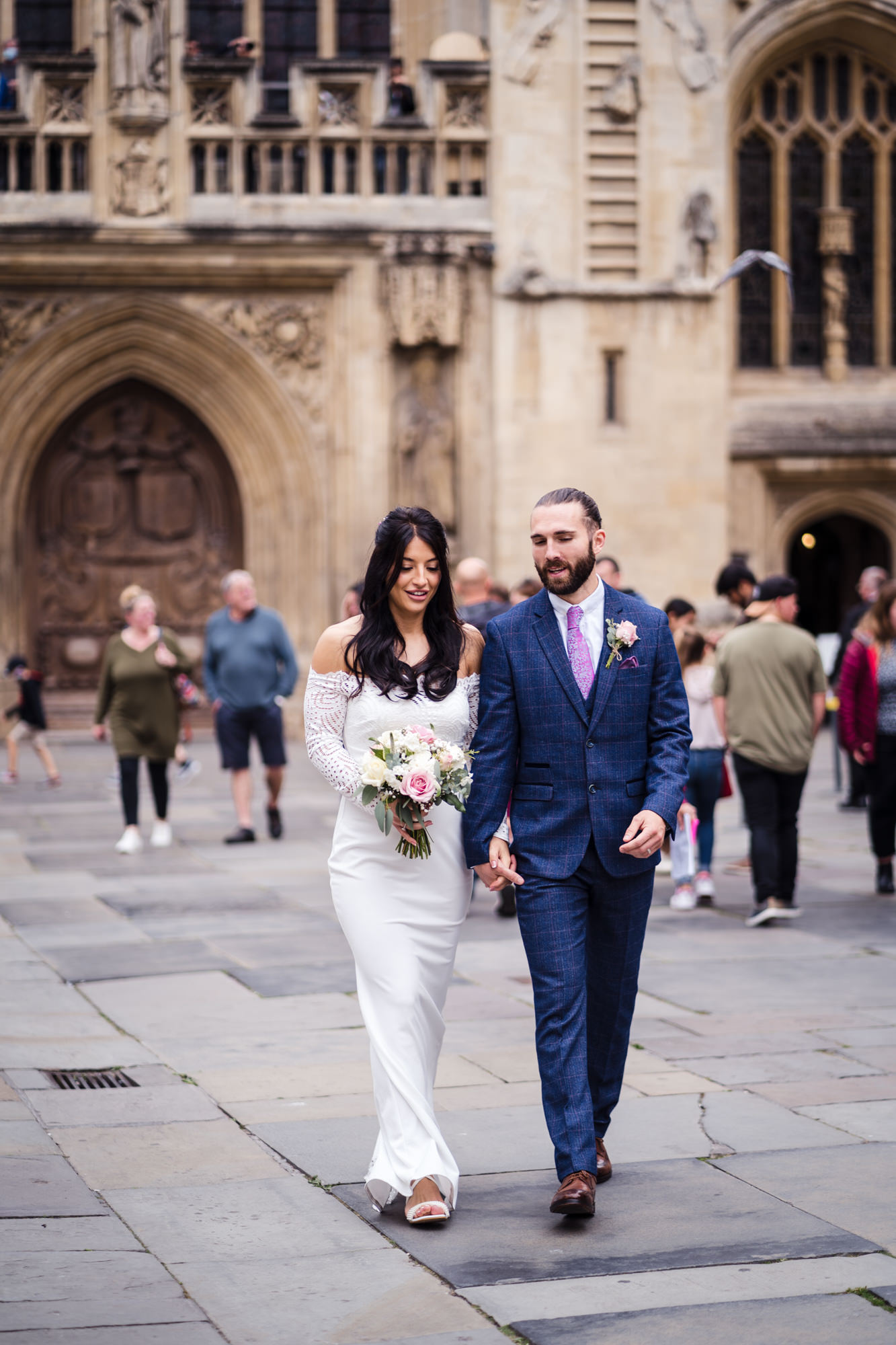 bride and groom hold hands and walked relaxed through bath city