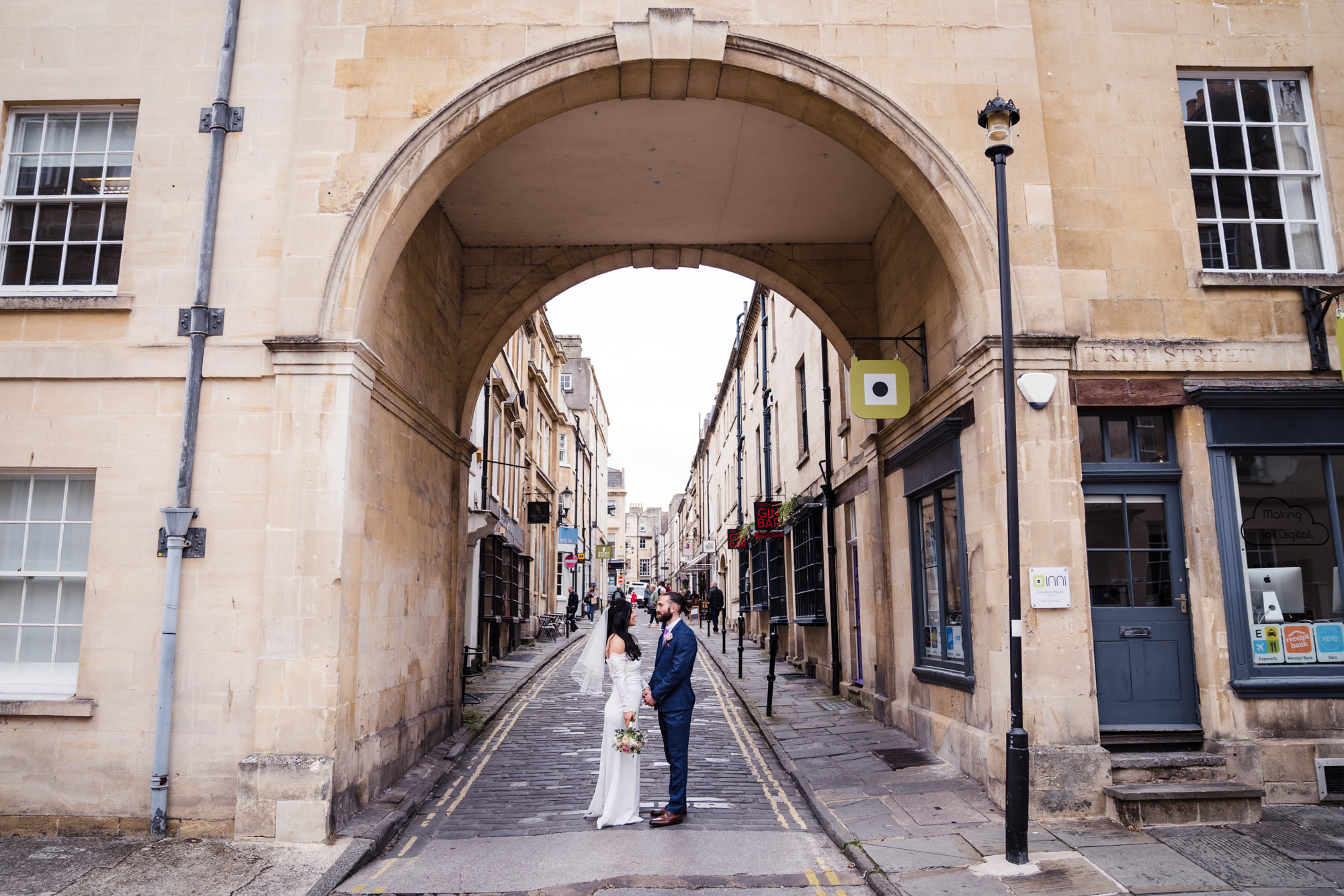 wide shot of couple on their wedding day in Bath showing off the limestone architecture