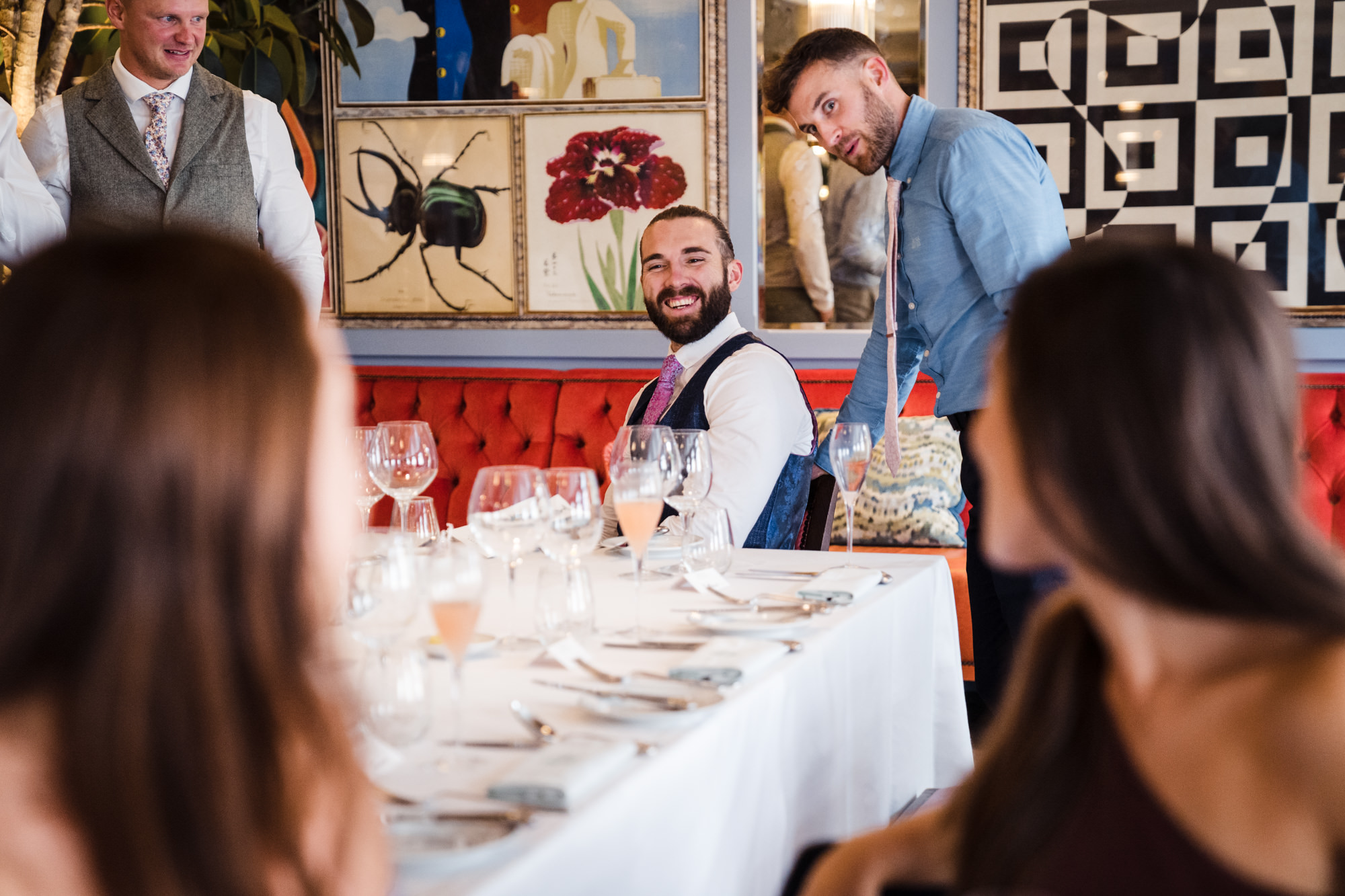 candid natural photo of groom enjoying speaking to his guests