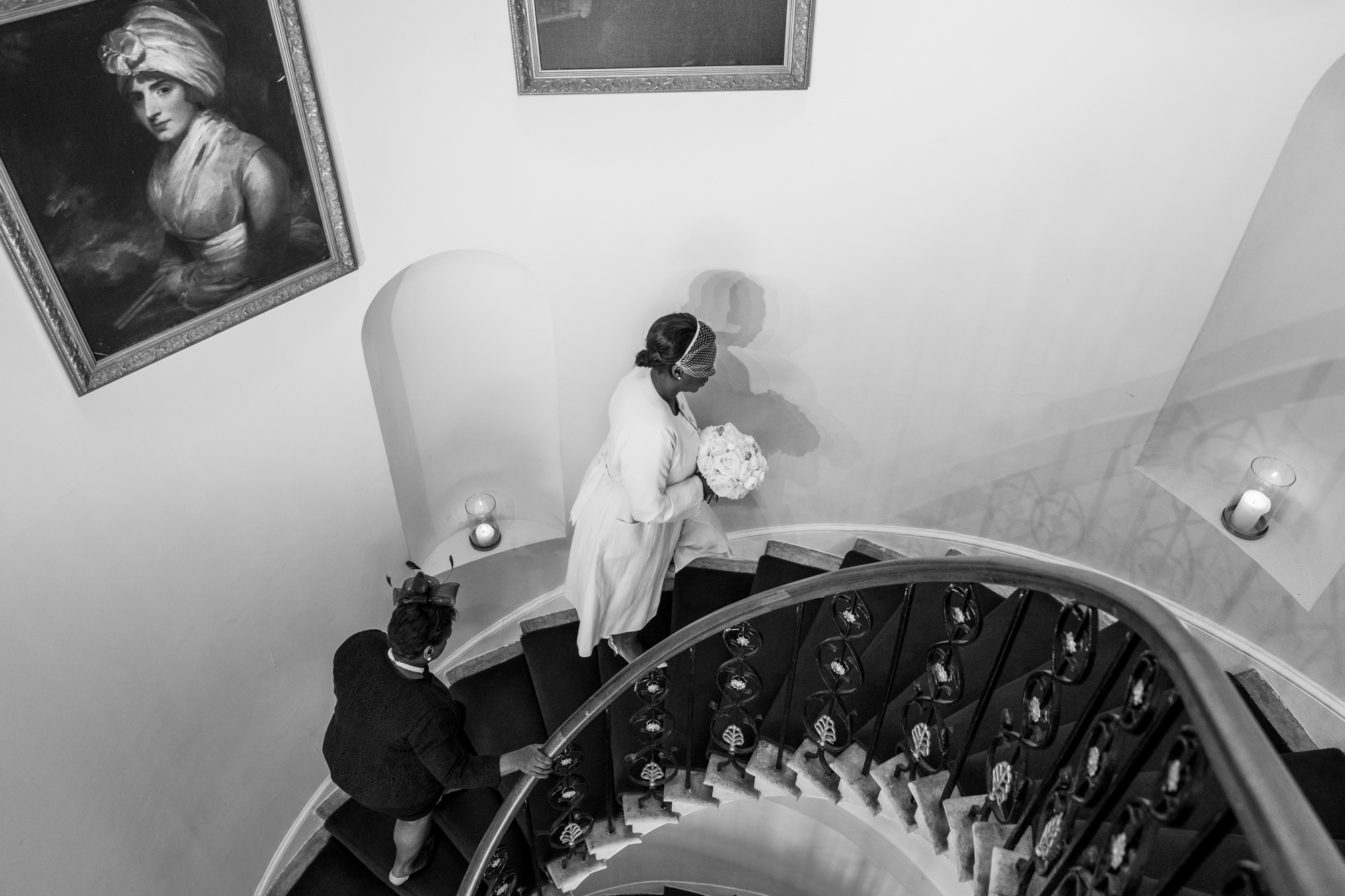 bride and her mum ascend the stairs at belair house wedding venue as they walk to the ceremony room