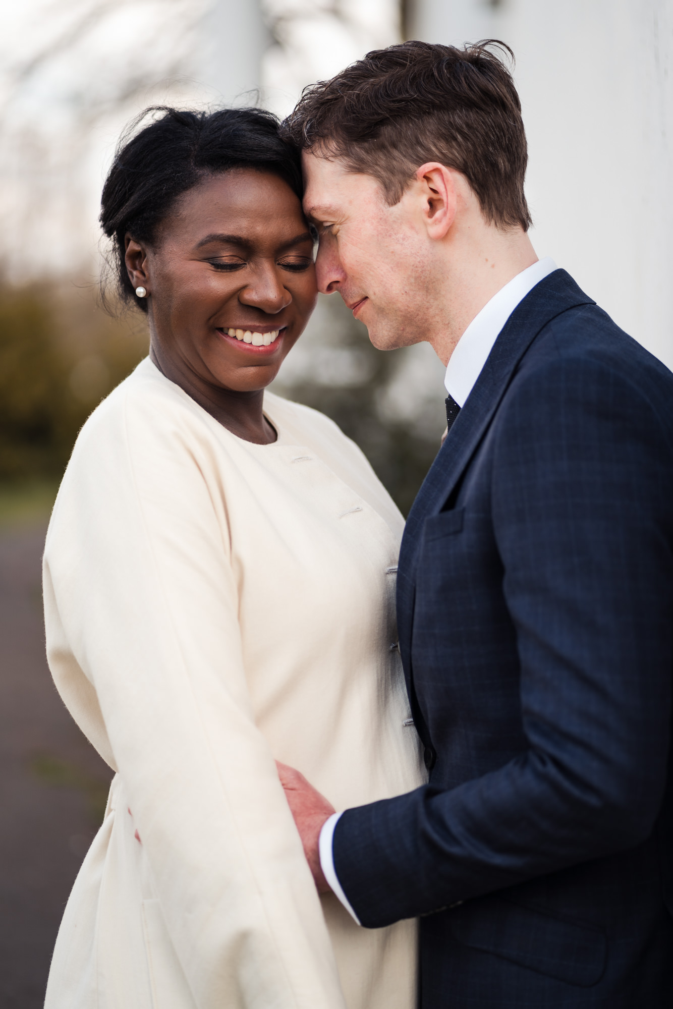 bride and groom embrace and smile for a couple wedding portrait photo