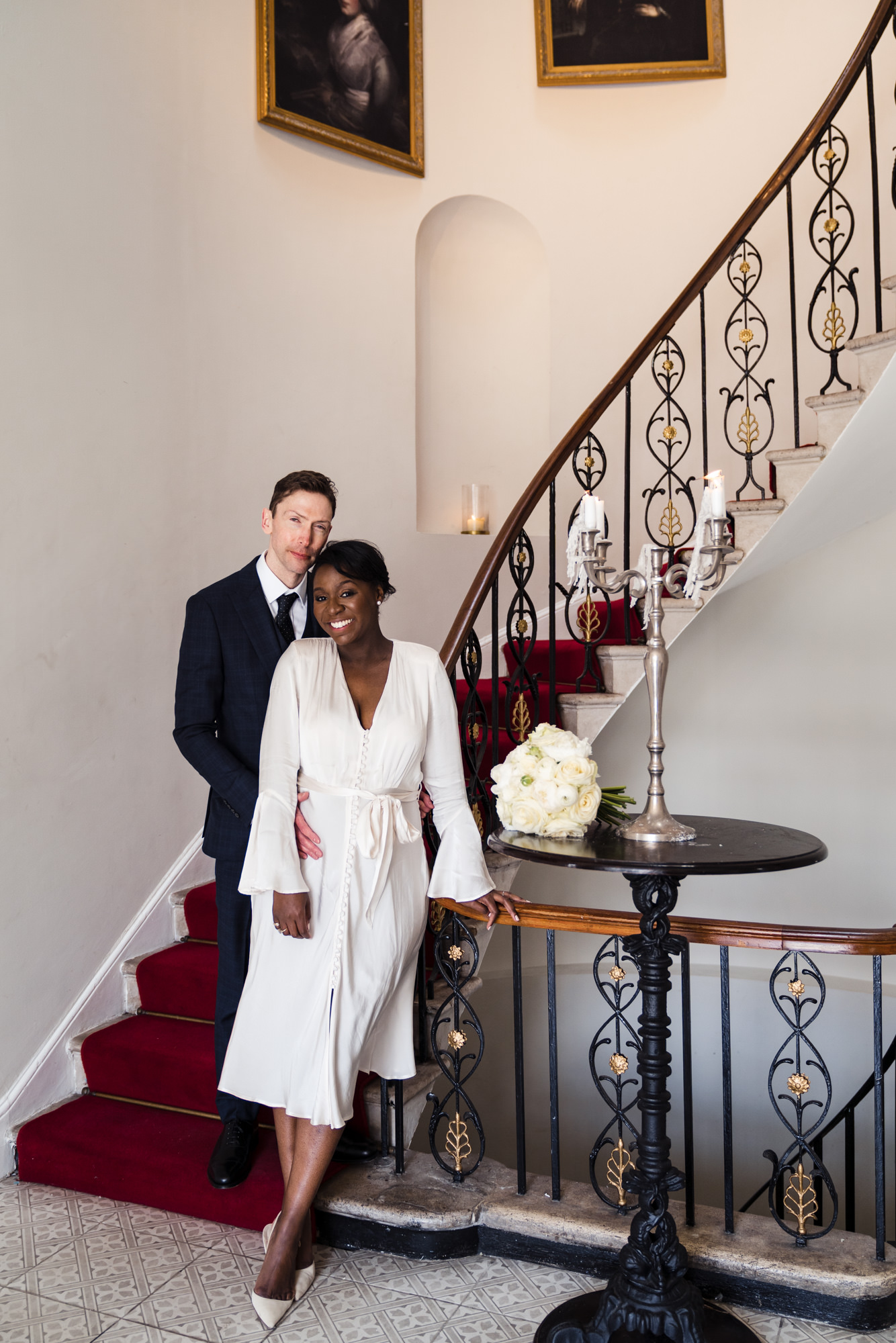 timeless bride and groom portrait of the couple stood on the stairs at belair house in south london