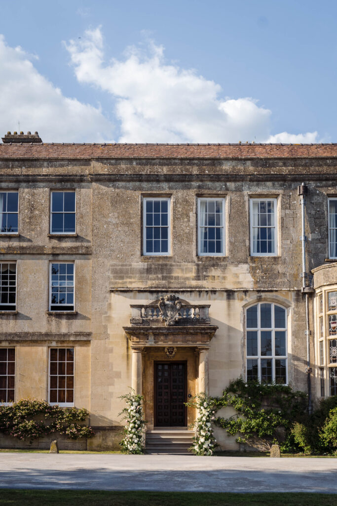 Elmore Court front entrance with floral arrangements around the doorway
